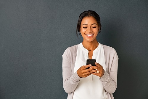 Woman texting a message on her smart phone. 