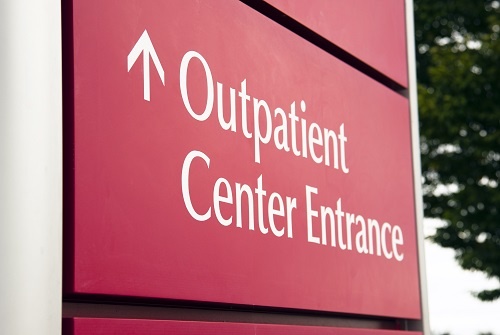 Big red hospital outpatient center sign.
