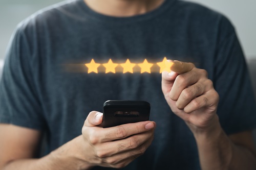 Close Up Of Man Customer Giving A Five Star Rating On Smartphone