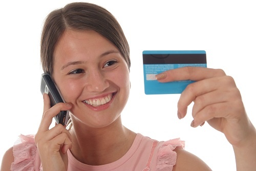 Girl with credit card and mobile phone.