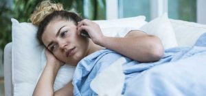 voice recording for medical offices helps a woman sick in bed on the phone