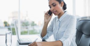 voice recording for medical offices helps a woman at work make a doctor's appointment through IVR prompts