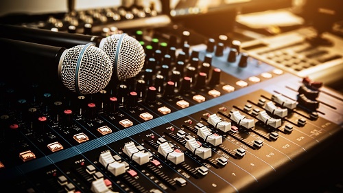 Microphone with sound mixer board in a studio.